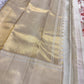 Handwoven ivory Butta saree with intricate floral jaal and soft antique-gold border.