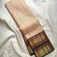 Deep maroon gold zari pallu with geometric lattice and repeated ornamental woven rows.