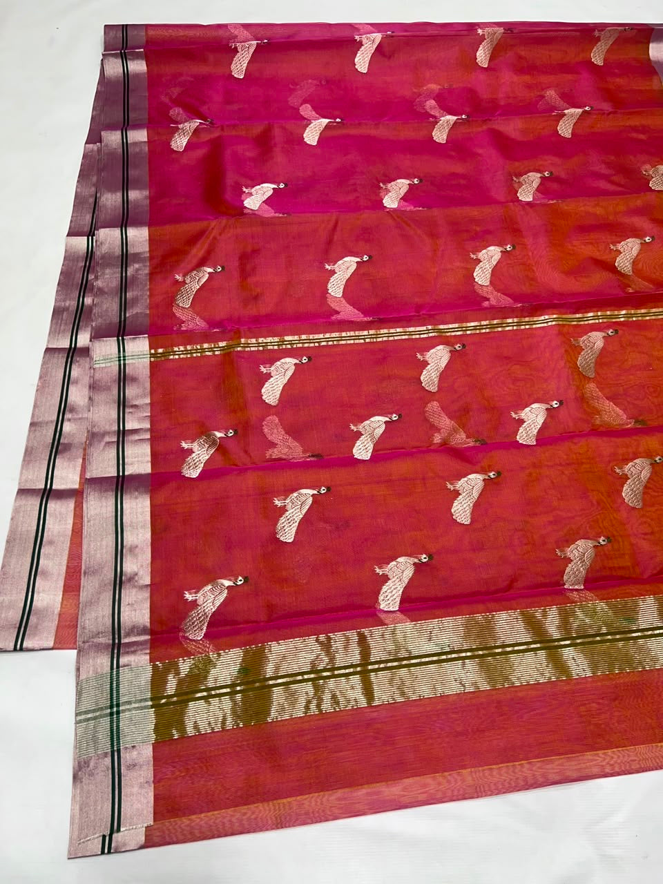 Orange-pink shot colour body close-up showing bird motifs