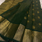 Full view of deep maragatham green with a soft petal pink pallu Kanchipuram saree showing airy butta placement across the body.