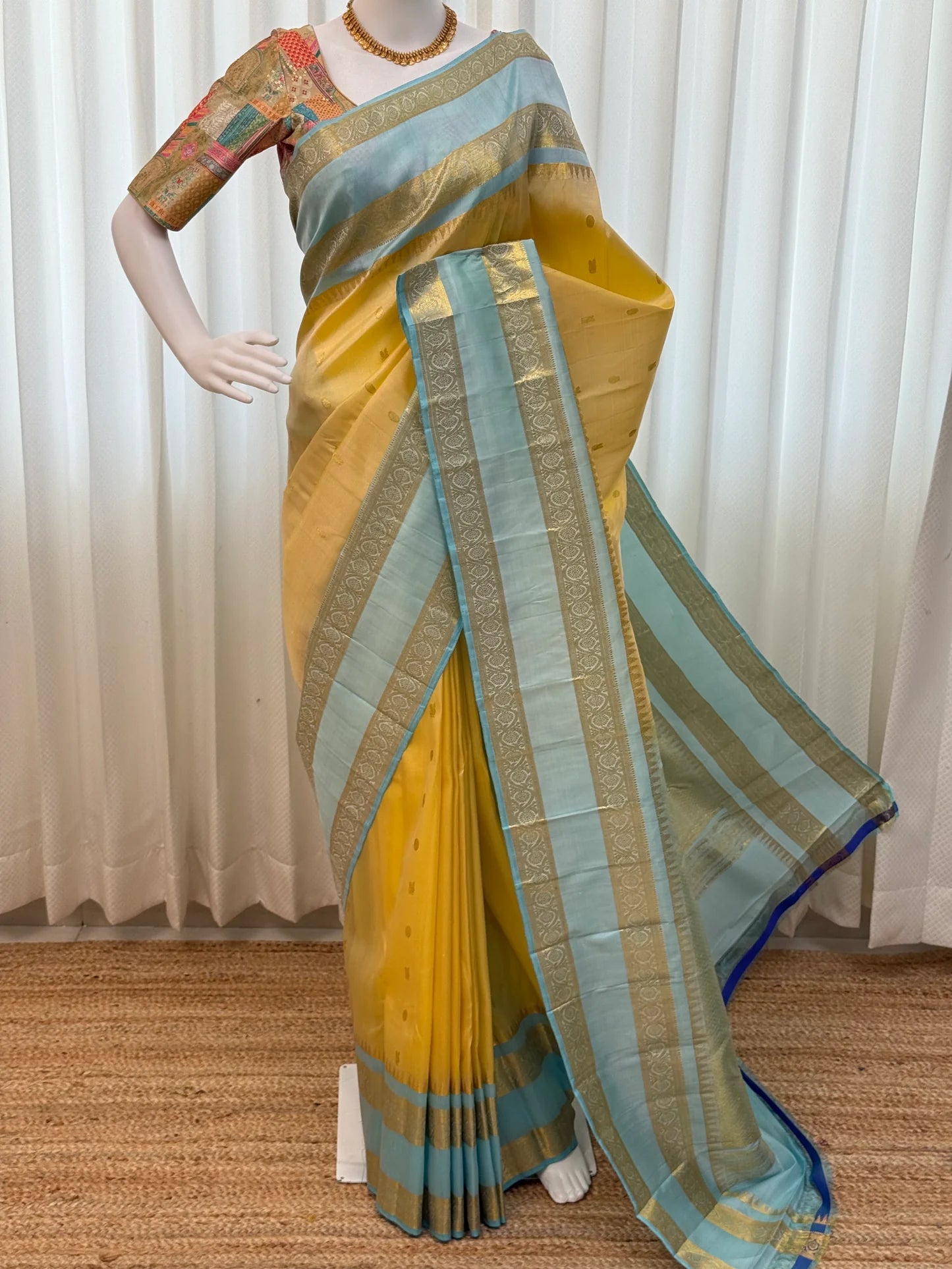 Full mannequin drape of butter yellow Pure Kanchipuram silk saree with sky blue pallu panels and zari woven border design