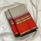 Fine biscuit-beige checks on a pure silk Kanchipuram saree body with orange Rettapet border