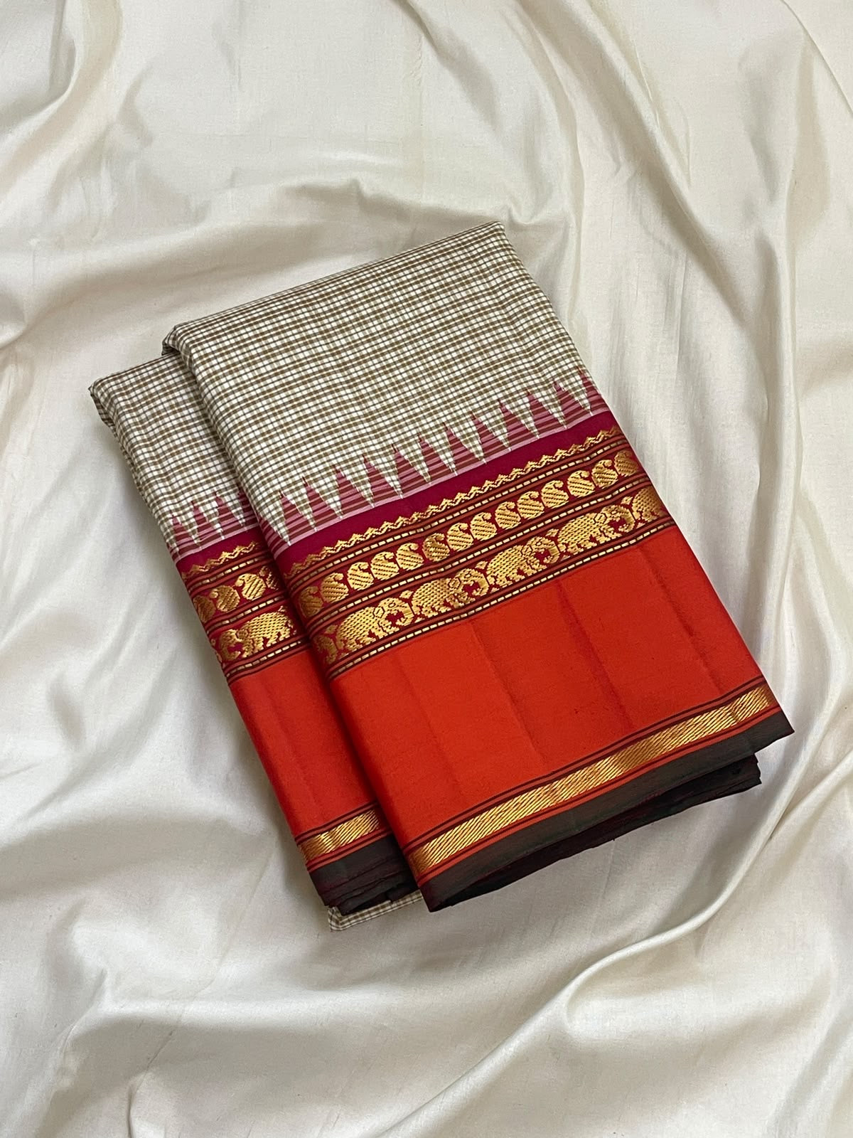 Fine biscuit-beige checks on a pure silk Kanchipuram saree body with orange Rettapet border