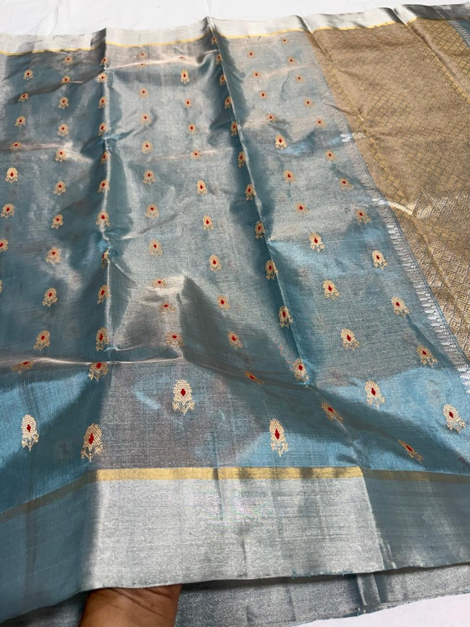 Full view of steel blue handloom Chanderi saree with gold motifs, red accents and intricately woven metallic pallu
