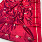 Close-up of silver floral buttas with green stems and leaves on Raspberry Red Pattu Silk Chanderi saree