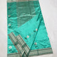 Silver floral buttas with deep green stems and leaves on an Aqua Turquoise Pattu Silk Chanderi saree