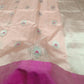 Detail of silver floral buttas with Rani Pink woven accents on a Blush Peach Chanderi silk saree