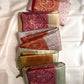 Silver Grey pure silk KanchiPattu Butta saree with Arakku Red Banarasi-style floral jaal zari border.