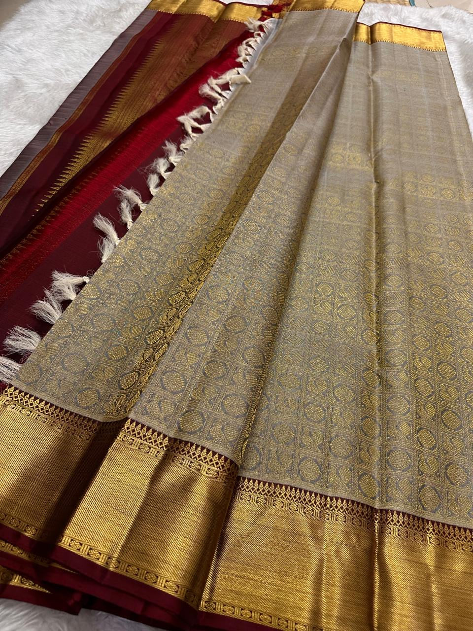 Close view of geometric gold zari weaving on Silver Grey Kanchipuram silk.