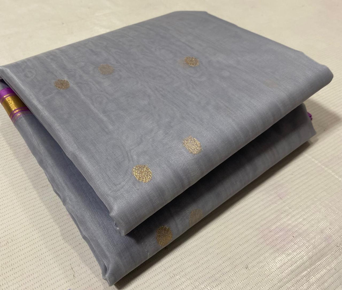 Pallu of silver grey Katan Silk Chanderi saree with large gold floral and paisley-inspired motifs