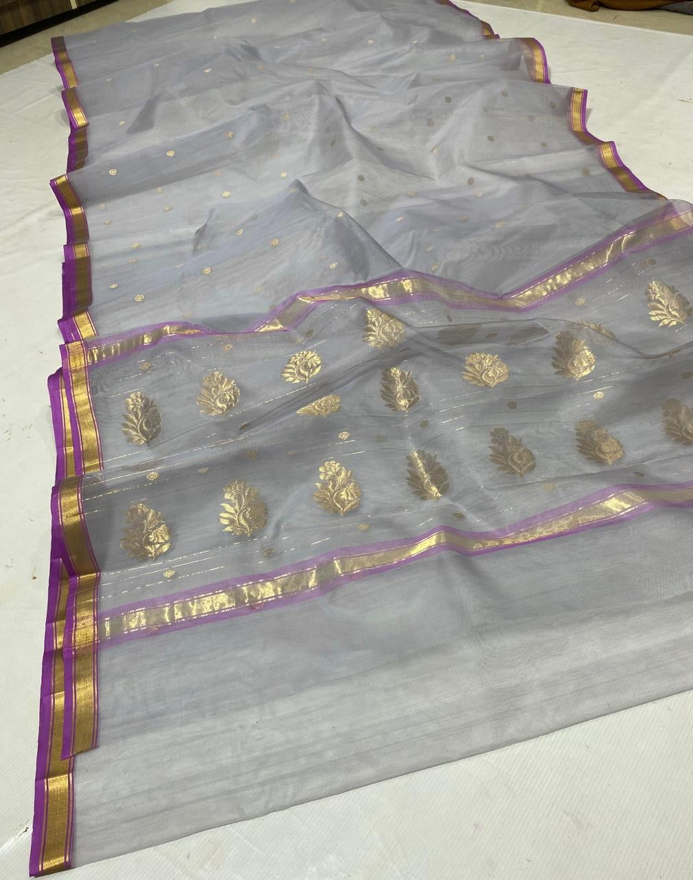 Silver grey handloom Katan Silk Chanderi saree draped to show body and border