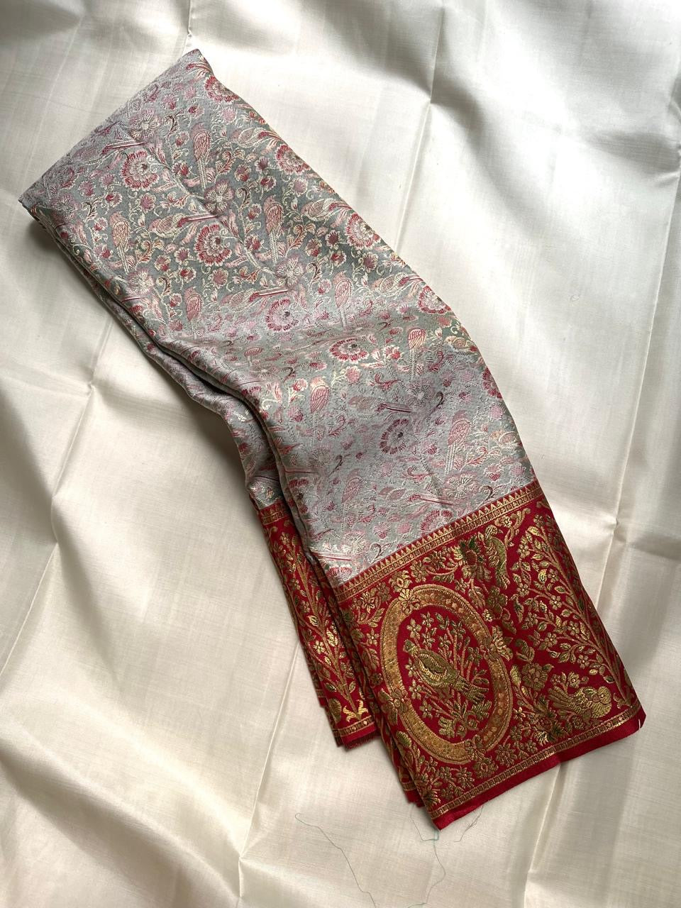 Silver Grey Kanchipuram silk saree with tone-intensive floral and foliate jaal weaving in rose and gold.