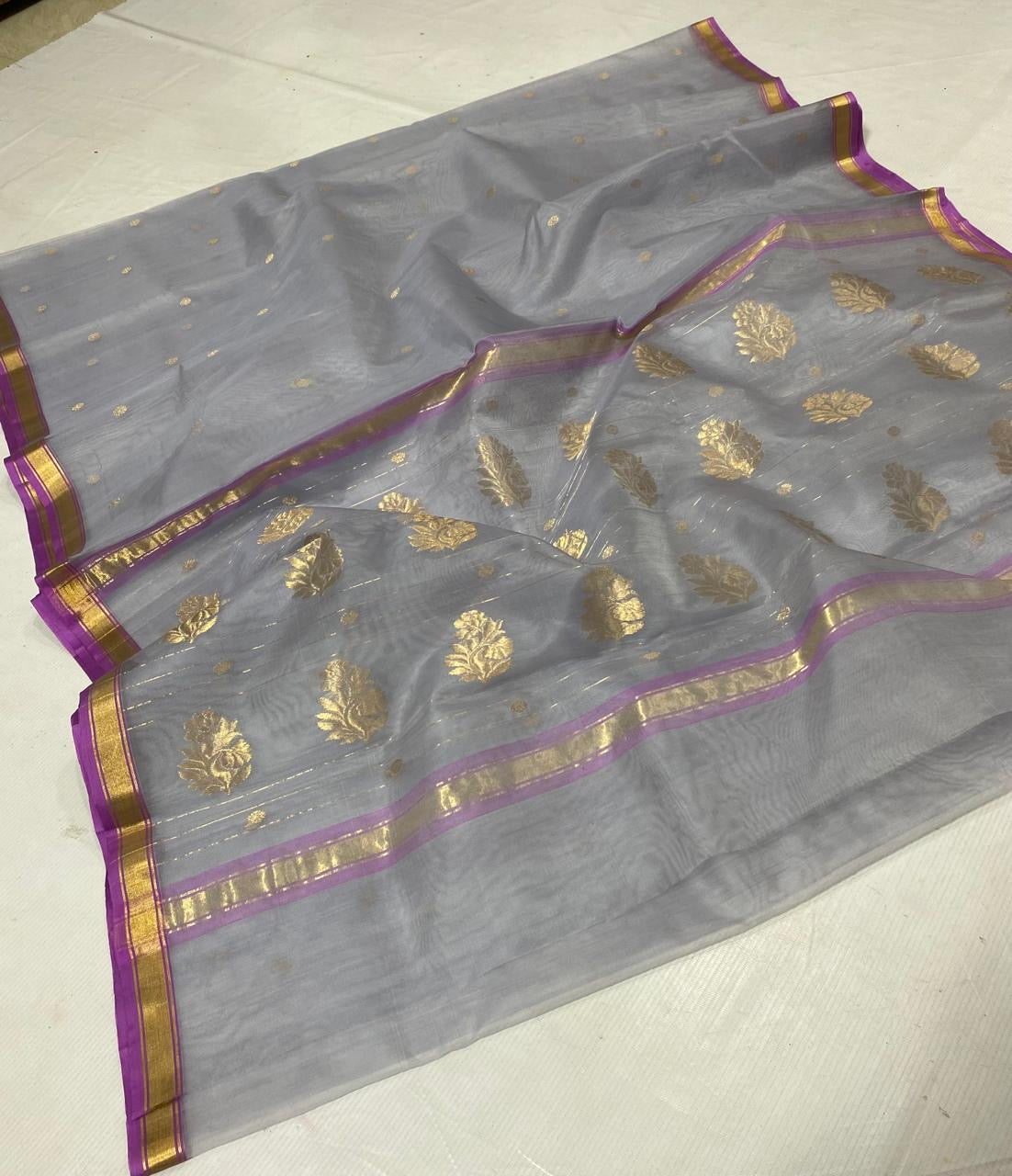Silver grey Chanderi saree with a narrow purple border and gold zari bands