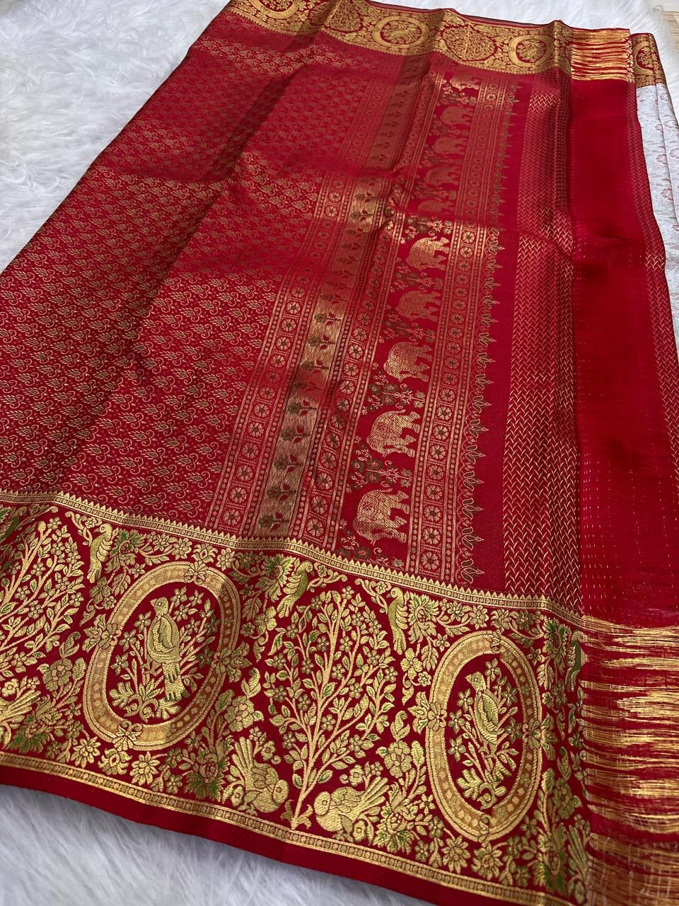 Broad Arakku Red Kanchipuram border woven with gold birds, flowering trees, foliage and oval medallions.