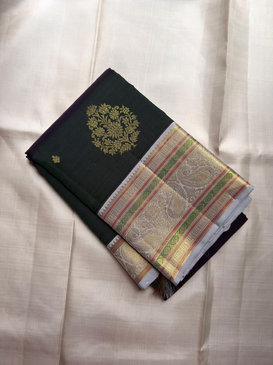 Green Floral-Chakram bands and Arakku accents on silver zari Kanchipuram border