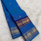 Silver zari buttas on the royal azure blue Kanjivaram Rettapet saree body