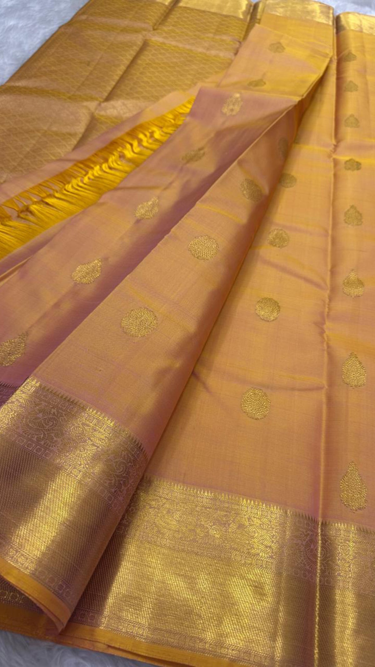 Sunset orange Kancheepuram silk saree with zari buttas, folded with running blouse piece