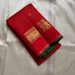 Full view of glowing red Kanjipuram silk showing fine zari grid, small buttas and traditional border