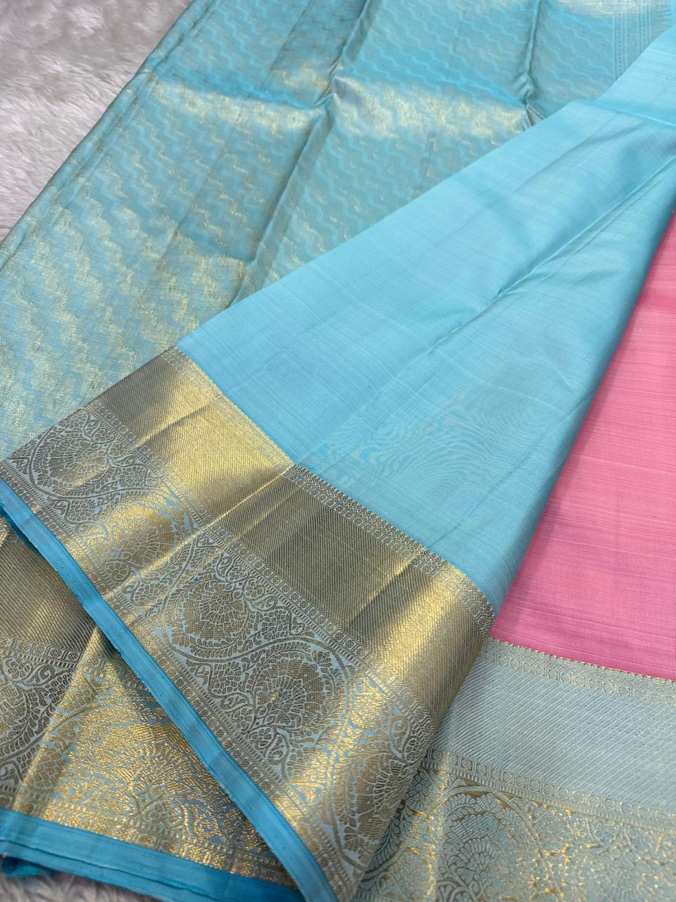 Sky blue pure Kanchipuram silk saree with gold zari woven pallu and sky blue border, pink fabric visible at the side, available in the USA