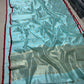 Sky blue body close-up showing gold-silver disc motifs
