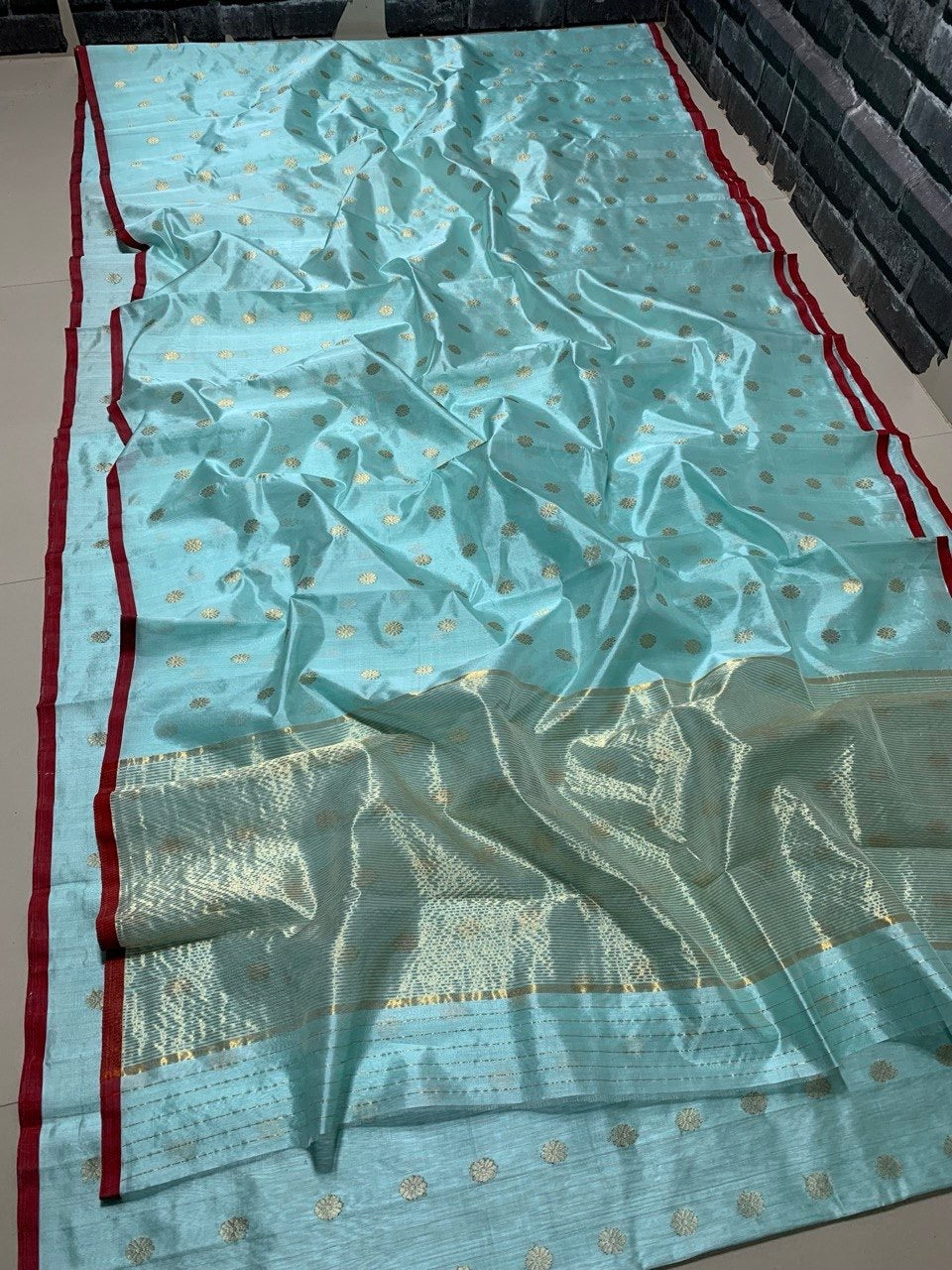Sky blue body close-up showing gold-silver disc motifs