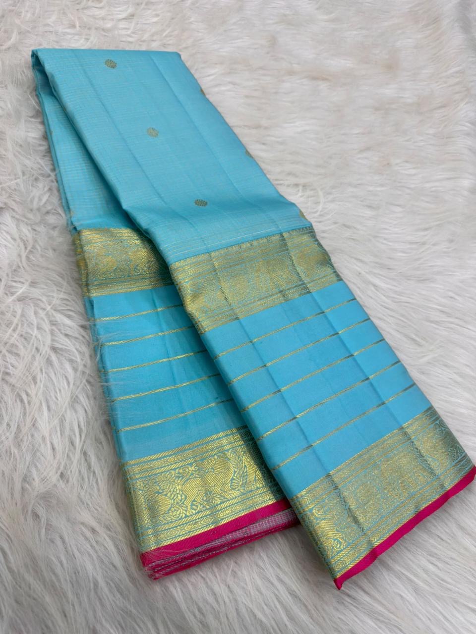 Light aqua blue Kanchipuram silk saree with rich antique-gold Varisaipet weaving.