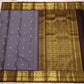 Gold zari peacock figures and Kamalam flowers on the dark Kaapi Brown Kanchipuram saree border