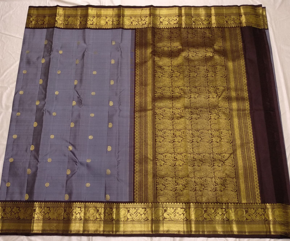Gold zari peacock figures and Kamalam flowers on the dark Kaapi Brown Kanchipuram saree border