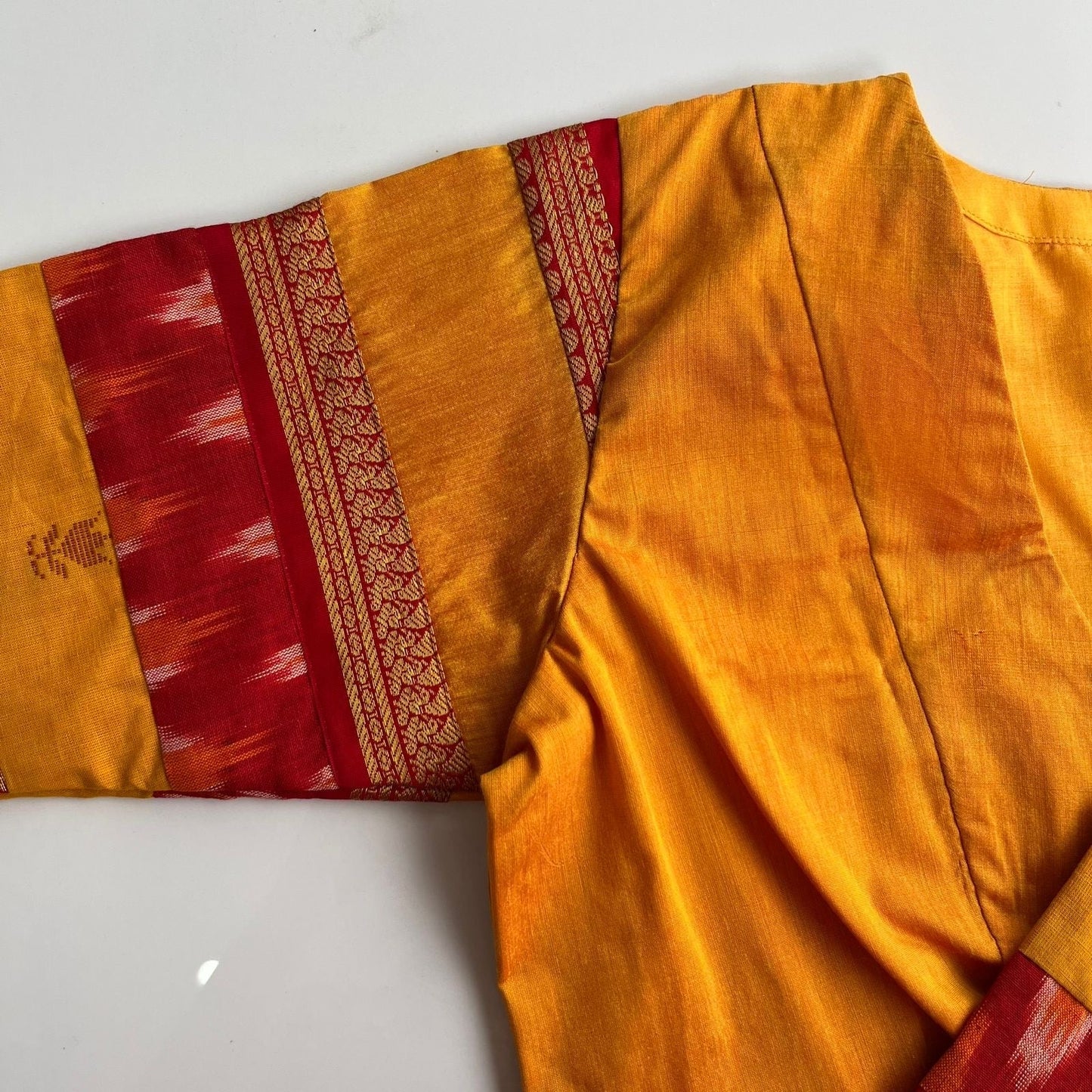 Artisan yellow blouse with handloom ikkat patterns and rich woven detailing by Idam Living