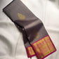 Smoky Charcoal Grey Pure Silk Kanchipuram Korvai saree with gold zari buttas and vibrant Rani Pink peacock border.