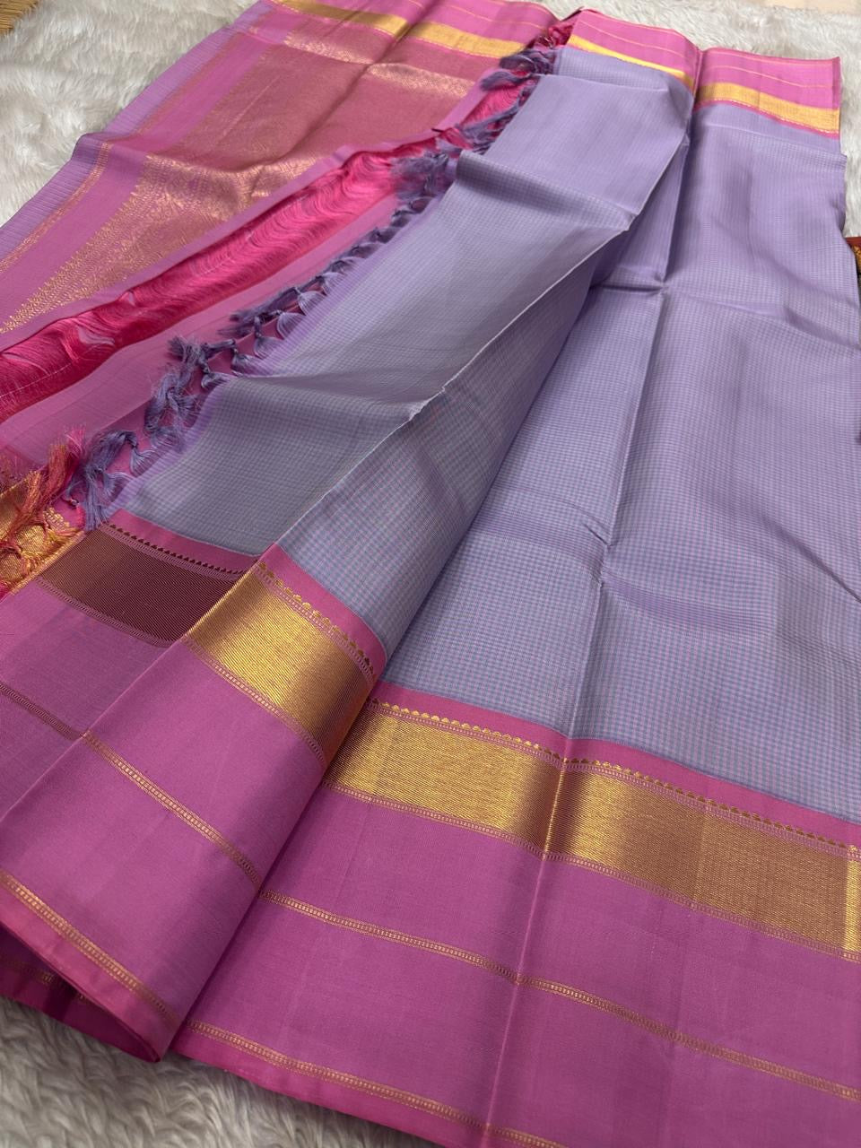 Kanchipattu silk saree in smoky lilac with raspberry pink border Korvai Kaal Irangiya Border weave traditional zari detail
