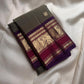 Smoky Olive Grey Kanchipuram body scattered with delicate gold zari buttas.