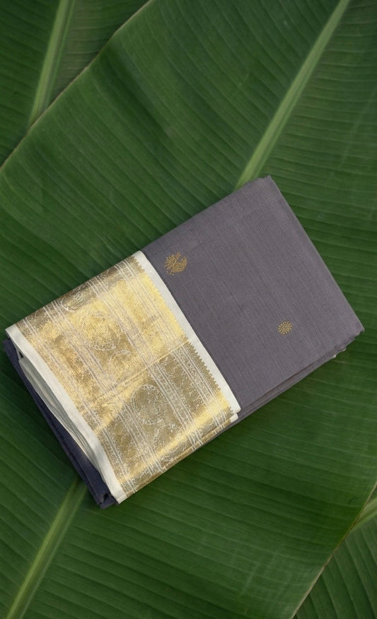 Smoky periwinkle Kanchipuram silk saree with ivory korvai border and mayil chakram zari butta folded view