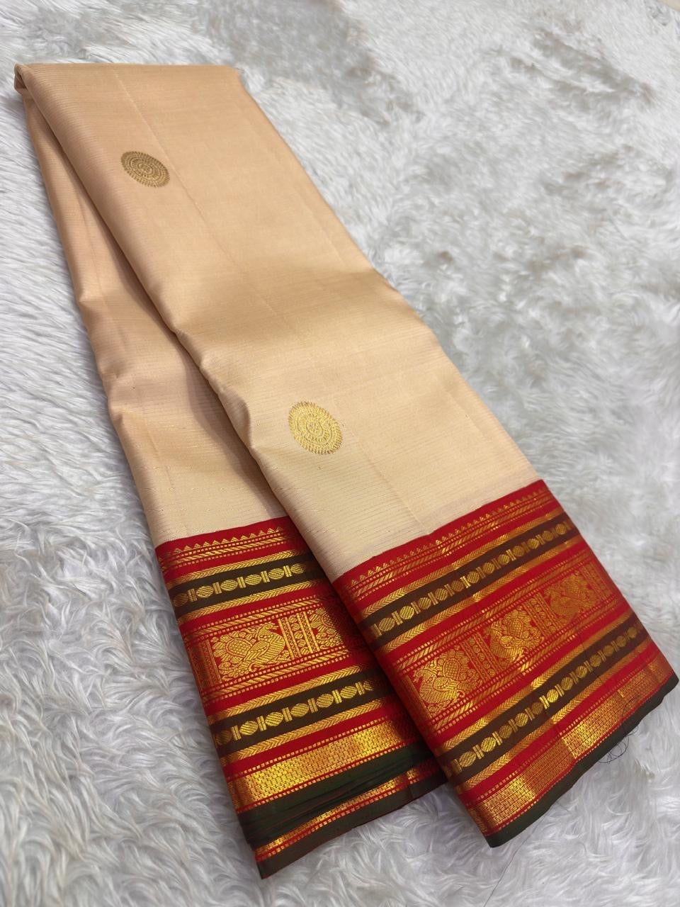 Soft Champagne Ivory Kanchi Pattu Saree — body close-up showing circular gold zari buttas