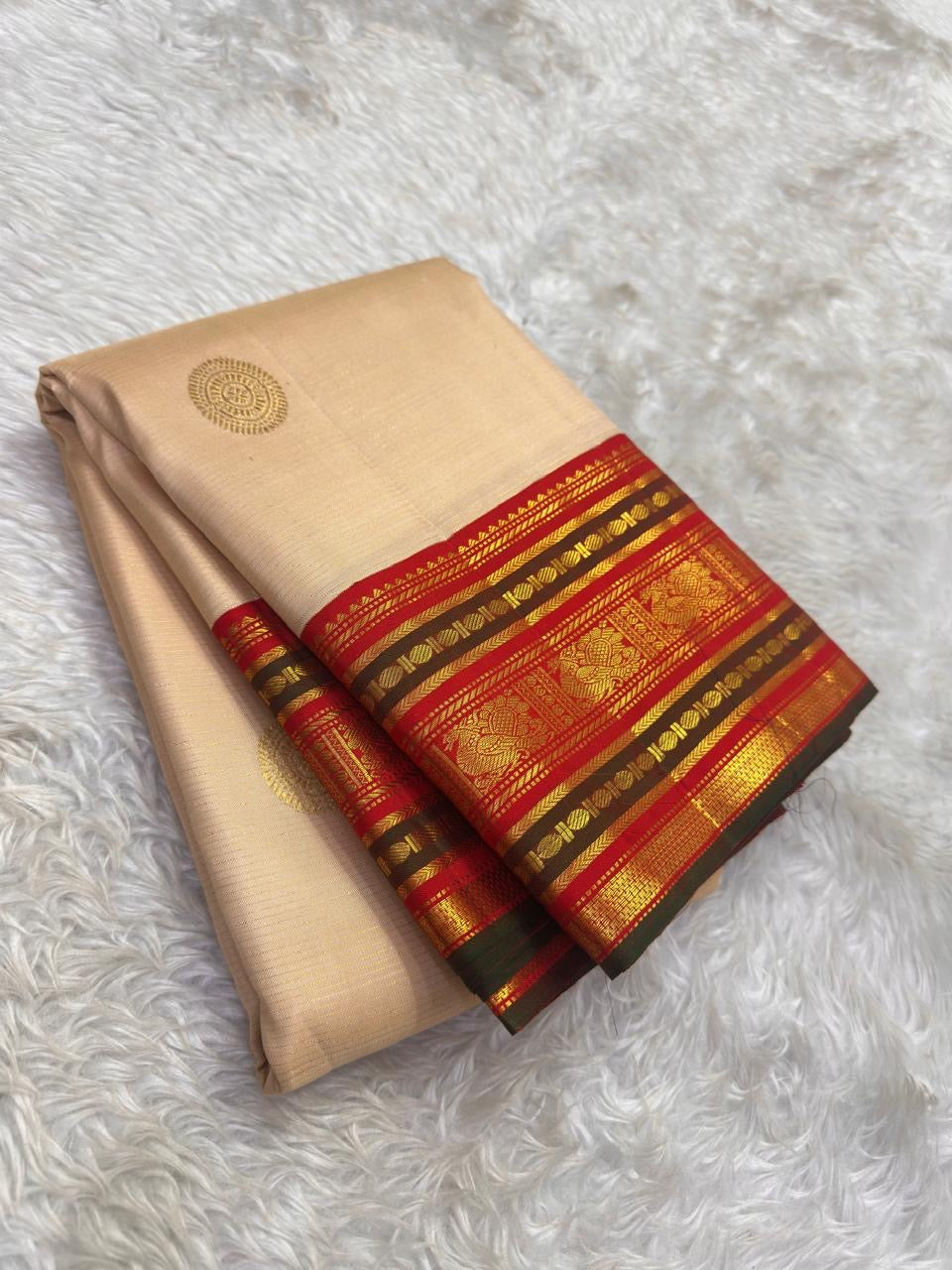 Soft Champagne Ivory Kanchi Pattu Saree — vermilion-red Korvai border with gold zari floral panels