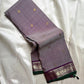 Grey pure Kanchipuram silk saree with scattered gold butti and a purple zari woven floral border with green edge.