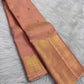 Soft Peach Blush Zari Kattam saree opened to show gold buttas, fine zari lines and tasselled pallu.