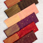 Open Soft Peach Blush Pure Silk Kanchipuram saree showing richly woven gold zari pallu and ornamental border.