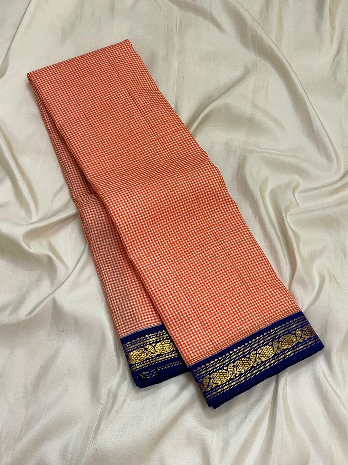 Soft peach ivory Kanjeevaram silk saree with royal blue zari border, full view