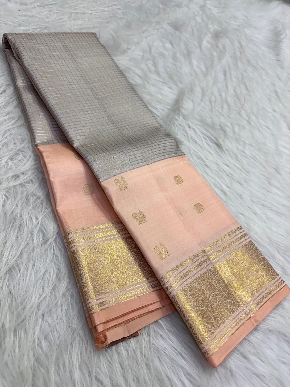 Soft Peach Pink Kanjivaram border with large antique-gold paisley motifs.