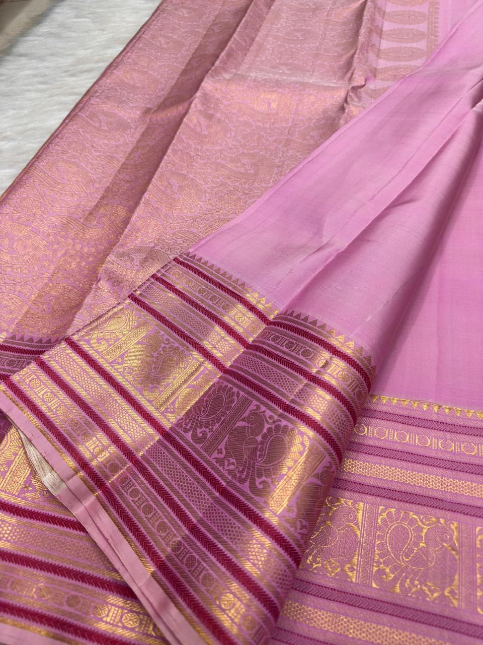 Soft Lotus Pink Kanjivaram silk with layered silk-thread zari border.