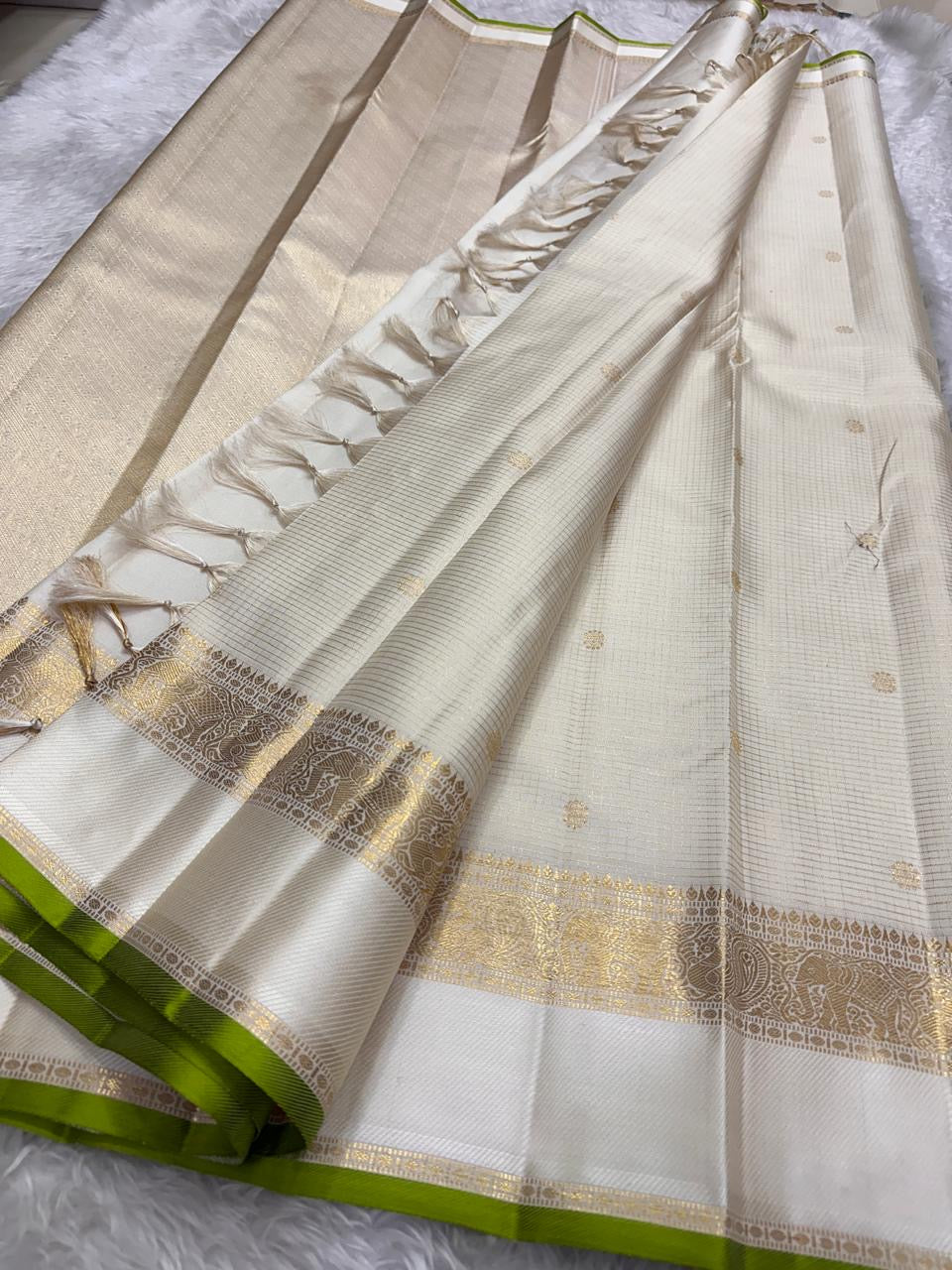 Elegant ivory and green Kanjivaram silk saree with elaborate pallu
