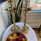 Pair of traditional brass Kuthu Vilakku lamps in a home setting with decorative flower bowl
