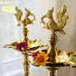 South Indian brass Kuthu Vilakku lamp pair styled with floating flowers in urli