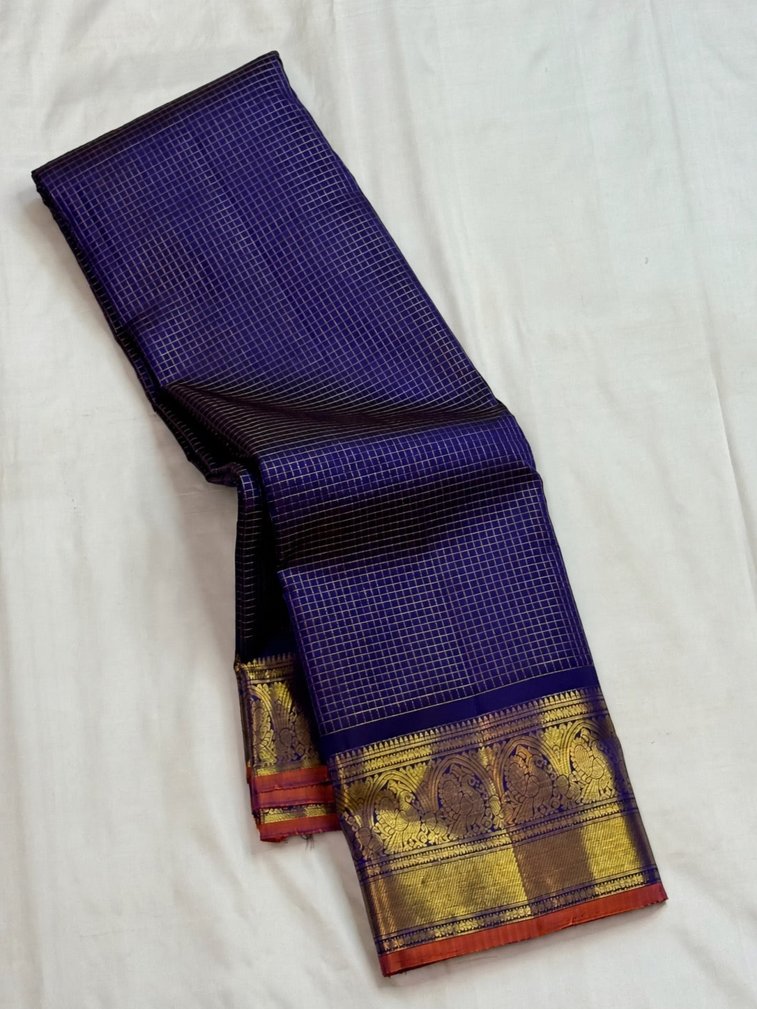 Deep blue Kanjivaram with muted copper-orange border edge