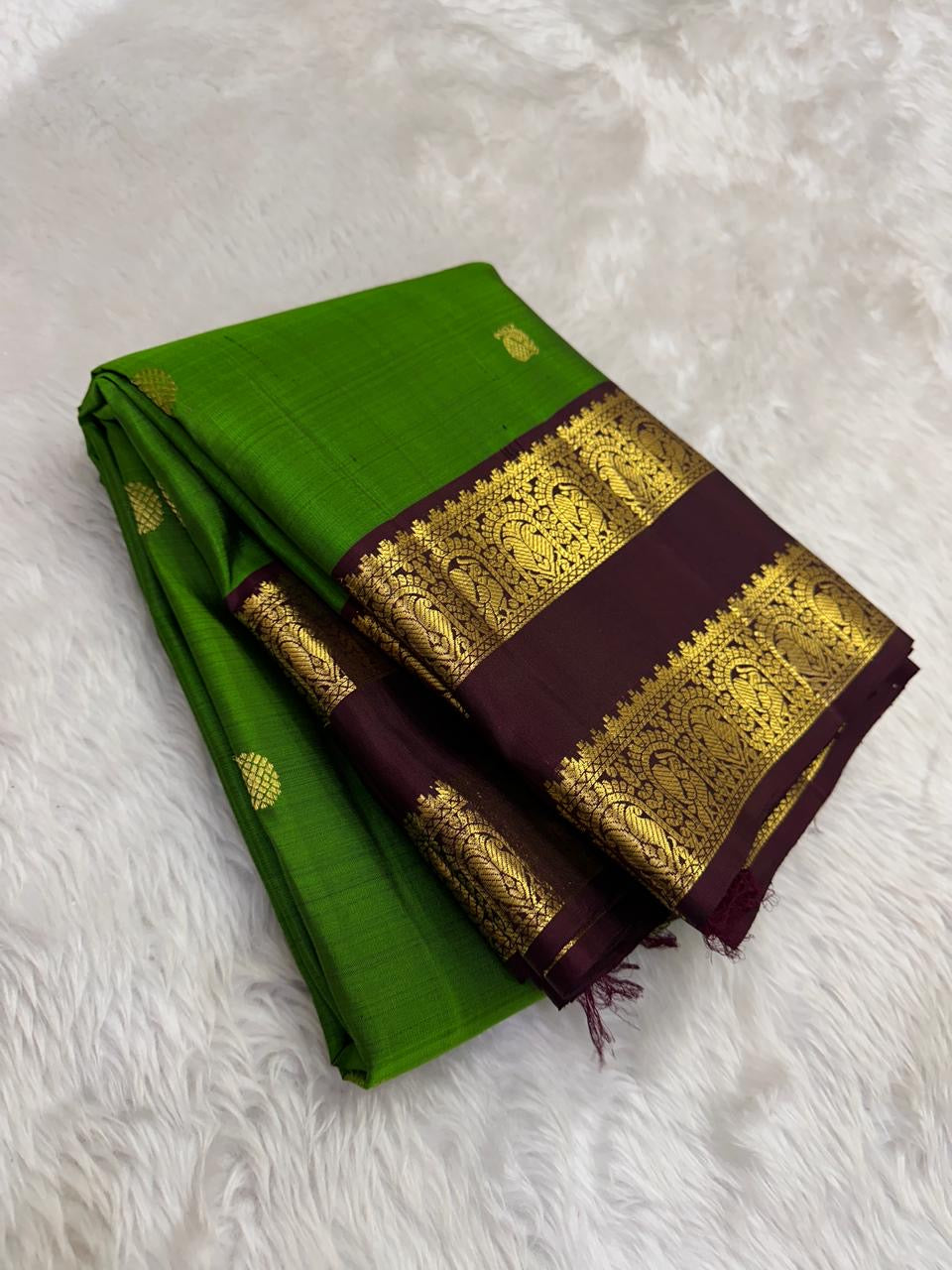 Vibrant parrot green Kanjivaram silk saree with coffee brown rettapet border traditional zari Idam Living