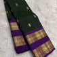 South Indian deep forest green Kanjivaram silk saree with violet rettapet border Idam Living