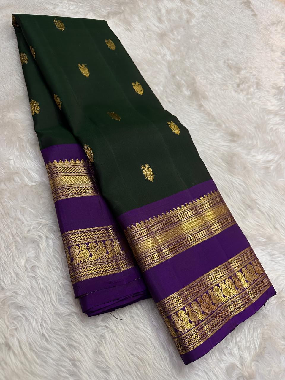 South Indian deep forest green Kanjivaram silk saree with violet rettapet border Idam Living