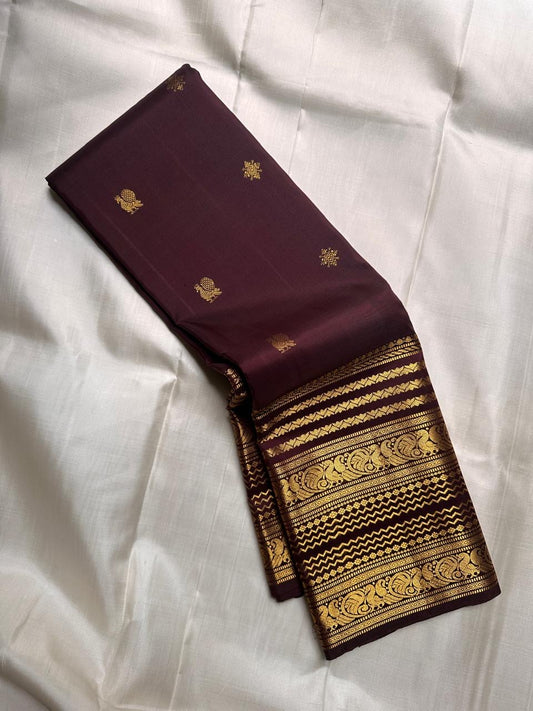 Pure Kanchipuram silk saree in deep brown with traditional gold zari varisaipet border