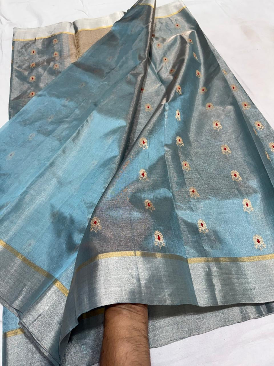 Steel blue handloom Chanderi saree showing spaced gold motifs with red centres and broad silver tissue border